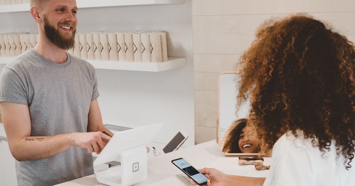 Retail operations manager reviewing customer data discrepancy across multiple screens in a modern store environment