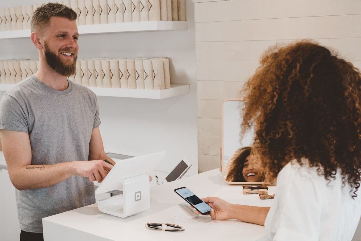 Retail store counter with payment terminal and invoices showing financial reconciliation across systems
